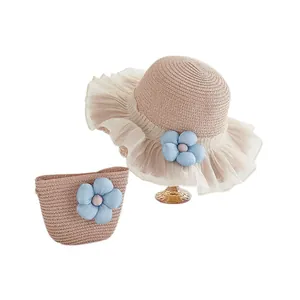 Pink straw sun hat and handbag set with blue flower decoration and white mesh brim