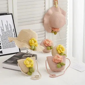 Close-up of summer straw hat and matching bag with large floral accents for girls