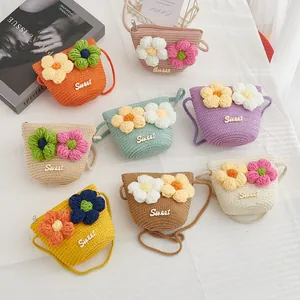 Detailed flat lay of colorful straw bags with crochet flower accents and zipper closure