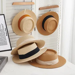 Flat top straw sun hats with elegant ribbon bows for summer beach vacations and sun protection