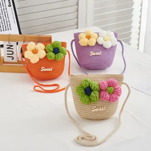 Detailed straw woven bags for girls featuring crochet flower accents and sweet metallic logo
