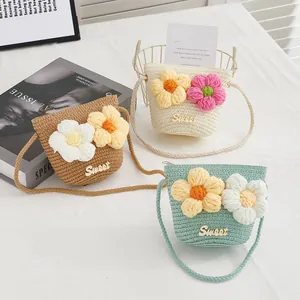 Close-up of three colorful straw bags for girls with knitted flowers and Sweet letter tags