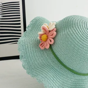 Light green straw sun hat for girls with woven floral accents and wavy edge trim