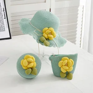 Detail of mint green straw sun hat and bags set with decorative yellow camellia flowers