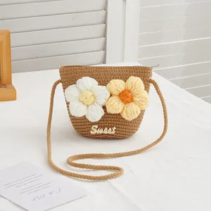 Detail of children straw crossbody bag with crochet flowers and Sweet lettering
