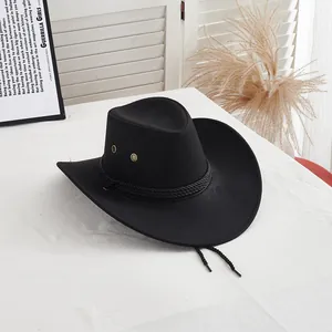 Detail of black western felt cowboy hat with woven band and metallic eyelets on brim