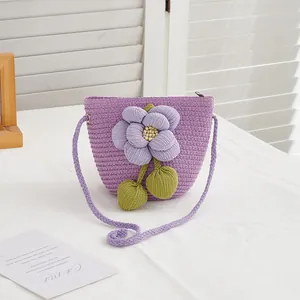 Detailed macro view of purple woven straw crossbody bag with large floral decoration
