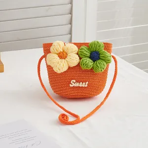 Detail of orange woven straw toddler bag with 3D crochet flowers and Sweet lettering