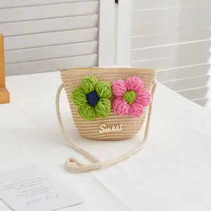Detail view of woven straw bag featuring 3D crochet flowers and secure metal zipper