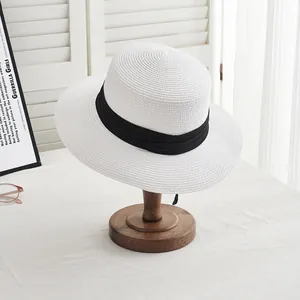 Classic white woven straw sun hat with black ribbon band for summer beach outings