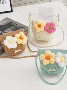 Trio of mini straw crossbody bags for girls with 3D knit flowers in brown, white and green