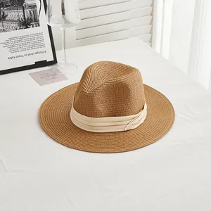 Dark brown straw fedora sun hat with a cream ribbon for outdoor summer vacations