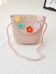 Pink woven straw crossbody bag for girls with colorful crochet flower decorations
