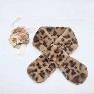 Detail of plush faux fur leopard print scarf featuring a crisscross fastening design