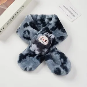 Detail of cross-style tie-dye plush scarf with cute embroidered cartoon character