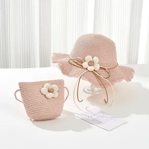 Pink woven straw sun hat and mini bag set with white fabric floral accents for kids