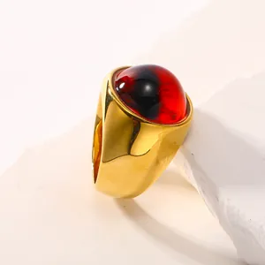 Bague en titane plaqué or 18 carats avec pierre œil du mal rouge et noire sur pierre