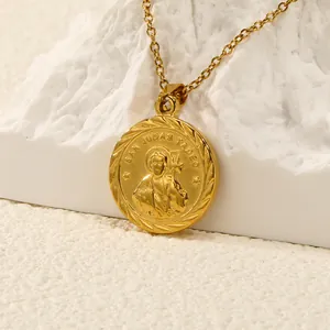 Macro shot of gold San Judas Tadeo medal pendant on white rock base with detailed wheat border