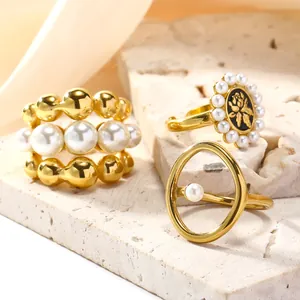 Three gold-plated titanium steel rings featuring pearls and vintage flower patterns