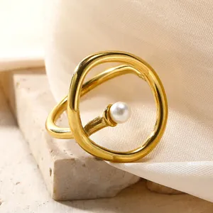 Detailed close-up of a gold titanium ring featuring an irregular design and a white pearl