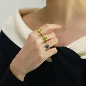 Three-piece gold-plated ring set featuring yellow, green, and blue oval cat's eye stones