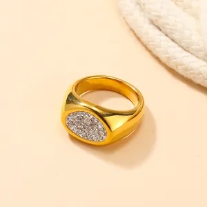 Gedetailleerde macro-opname van een ovale gouden zegelring met witte zirkonia-stenen