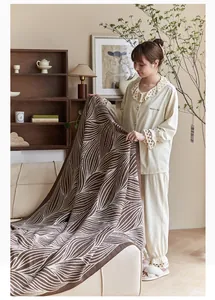 Detail of Nordic jacquard leaf pattern knit blanket showing thick weave and soft cotton texture