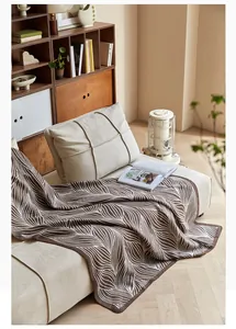 Detail of Nordic jacquard knitted blanket with white leaf veins on dark brown fabric