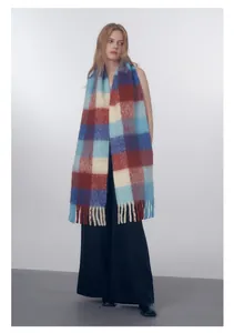 Detail of wool blend gradient plaid scarf with long fringes and vibrant color block design