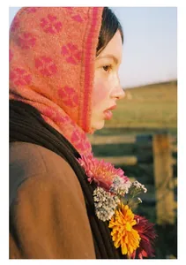 Detail of four-leaf clover jacquard knit balaclava in orange and pink floral pattern