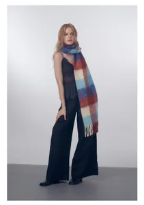 Close-up of thick gradient plaid scarf showing wool blend texture and fringe detail