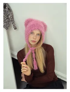 Close-up of pink faux fur winter beanie with cute animal ears and long tassels