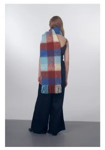 Detail of wool blend gradient plaid scarf with thick fringes and soft fuzzy texture