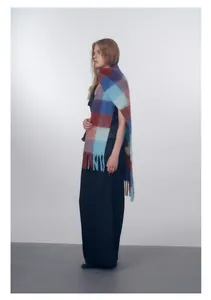 Close-up of multicolored gradient wool blend plaid scarf with fine fringe tassels