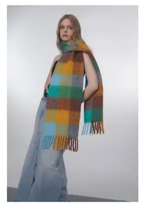 Close-up of vibrant gradient check wool blend scarf with thick long tassels