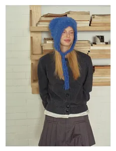 Close-up of royal blue knitted balaclava with colorful speckles and long straps