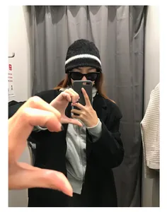 Detail einer schwarz-weiß gestreiften Strickmütze getragen im lässigen Streetstyle-Look