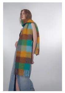 Close-up of vibrant gradient check wool blend scarf with thick decorative tassels