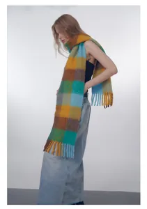 Detailed view of heavy wool blend plaid scarf in yellow and blue with long fringe edges