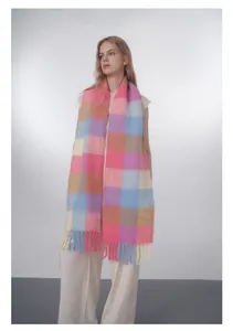 Close-up of soft gradient plaid wool scarf with colorful fringe detail and thick texture