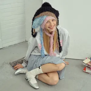 Colorful layered knit balaclava hat with bear ears and long fringe tassels on model