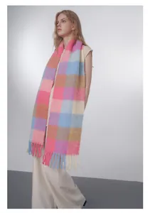 Detail of soft pastel gradient plaid wool blend scarf featuring decorative fringe tassels