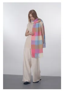 Detailed view of colorful gradient plaid wool scarf with decorative soft fringe textures