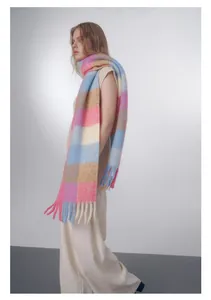 Detail of soft pastel gradient plaid scarf with long fringe and thick wool blend texture