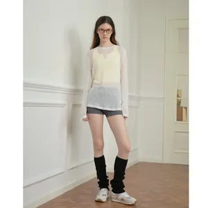 Top minimalista de punto blanco con calentadores negros y pantalones cortos de yoga