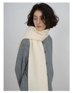 Detail of soft cream wool blend scarf showing the delicate knit texture and material