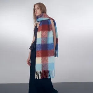 Chunky wool blend scarf featuring blue and burgundy gradient plaid with fringe detail