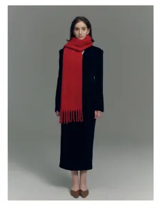 Close-up of bright red wool blend scarf with long tassels and soft fuzzy texture