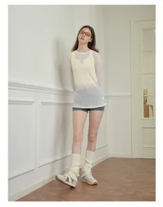 Full body view of a white knit lace top paired with slouchy leg warmer socks