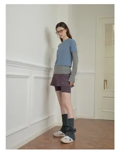 Detailed styling of wool blend leg warmers with grey slouchy socks and athletic shoes